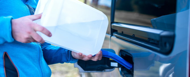 Someone pouring AdBlue in the Adblue tank