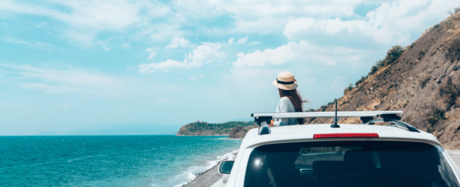 A Woman in a car staring at the sea